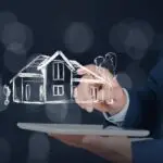 Person using a laptop with an AI hologram